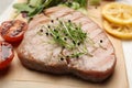 Delicious tuna steak with microgreens on parchment paper