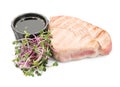 Delicious tuna steak with sauce and microgreens isolated
