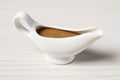 Delicious turkey gravy in sauce boat on white wooden table Royalty Free Stock Photo