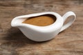 Delicious turkey gravy in sauce boat on wooden table Royalty Free Stock Photo