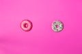Delicious two donuts, pink and white on color background, top view Royalty Free Stock Photo