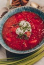 Delicious Ukrainian and Russian traditional beet soup borsh with sour cream in a bowl. Beautiful close-up photo Royalty Free Stock Photo