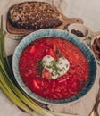 Delicious Ukrainian and Russian traditional beet soup borsh with sour cream in a bowl. Close-up photo Royalty Free Stock Photo