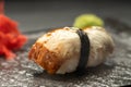Delicious Unagi Eel Nigiri Sushi on black stone background. Traditional Japanese cuisine
