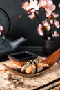 Delicious Unagi Eel Nigiri Sushi Eel Sushi . Dish decorated with a sprig of cherry blossoms.