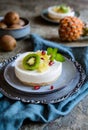 Unbaked mini cheesecakes topped with pineapple, kiwi and pomegranate Royalty Free Stock Photo