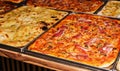 large pizzas with mushrooms and cheese, made on two metal trays