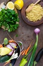 Delicious useful porridge cous cous in a clay plate and raw fresh vegetables in a basket