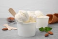 Delicious vanilla ice cream in paper cup on light grey table Royalty Free Stock Photo