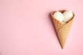 Delicious vanilla ice cream in wafer cone on pink background. Space for text Royalty Free Stock Photo