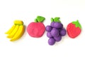 Delicious variety fruits plasticine, colorful clay dough, white background