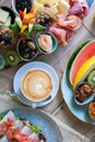 Delicious and various delicacies with veggies, fruits and a cup of latte