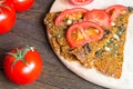 Delicious vegan crisp bread with tomatoes on wooden background