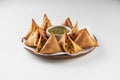 Delicious Vegetable Samosas with Mint Chutney on Wooden Platter Royalty Free Stock Photo