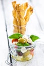 Delicious vegetable tapas in a glass with crunchy homemade grissini.