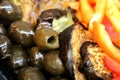 Delicious vegetables in brown, orange, orange and yellow, fire colors on a plate, eggplant, yellow and orange tomatoes,olives,