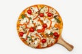 Delicious Vegetarian pizza served on a wooden plate, the ingredients are signature sauce, basil, mozzarella cheese Royalty Free Stock Photo