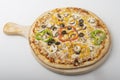 Delicious Vegetarian pizza served on wooden plate Royalty Free Stock Photo