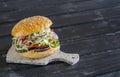 Delicious veggie burger on a dark wooden surface. Healthy breakfast