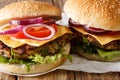 Delicious veggie burger with mushroom patty, fresh lettuce, onions, tomatoes and cheddar cheese close-up. horizontal