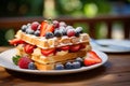 Delicious viennese waffles with fresh berries and syrup served on an outdoor caf table Royalty Free Stock Photo