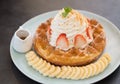 Delicious waffle with whipped cream and strawberry topping, eat Royalty Free Stock Photo