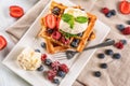 Delicious waffles with berries and ice cream on plate Royalty Free Stock Photo