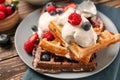 Delicious waffles with berries and ice cream on plate Royalty Free Stock Photo