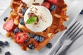 Delicious waffles with berries and ice cream on plate, closeup Royalty Free Stock Photo