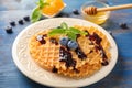 Delicious waffles with blueberry jam on plate Royalty Free Stock Photo