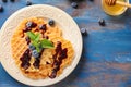 Delicious waffles with blueberry jam on plate Royalty Free Stock Photo