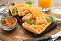 Delicious waffles with orange slices on wooden table Royalty Free Stock Photo