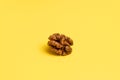 Delicious walnuts on yellow background.