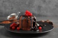 Delicious warm chocolate lava cake with berries on grey table Royalty Free Stock Photo