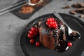 Delicious warm chocolate lava cake with berries on grey table, closeup Royalty Free Stock Photo
