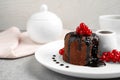 Delicious warm chocolate lava cake with berries on plate