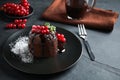 Delicious warm cake with mint and berries on dark grey table Royalty Free Stock Photo
