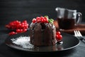 Delicious warm chocolate lava cake with mint and berries on dark grey table Royalty Free Stock Photo