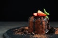 Delicious warm chocolate lava cake on slate board, closeup. Space for text
