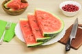 Delicious watermelon on a light wooden background. Three slices of berries ripe red watermelon on a white plate standing Royalty Free Stock Photo