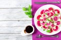 Delicious watermelon radish salad with mozzarella, onion chives