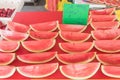 Delicious watermelon slice cuts in cling film with price tags at market stand in Singapore Royalty Free Stock Photo