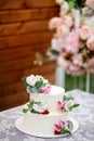 Delicious wedding cake decorated white icing with exotic flowers Royalty Free Stock Photo