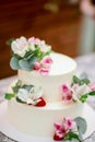 Delicious wedding cake decorated white icing with exotic flowers Royalty Free Stock Photo