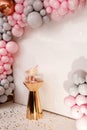 Delicious wedding reception. Birthday Cake on a background balloons party decor. Copy space. Candy bar