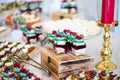 Delicious wedding reception candy bar dessert table full with cakes and sweets and a candles Royalty Free Stock Photo