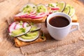 Delicious wheat toasts with radish, avocado and sprouts