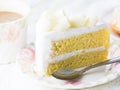 Delicious white chocolate cake on beautiful plate and a cup of coffee on wooden table Royalty Free Stock Photo