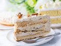 Delicious white chocolate cakes and a piece of coffee cake with almond and raisin on top. selective focus shallowed DOF Royalty Free Stock Photo