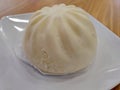 Delicious white loaf of steamed buns on a white plate